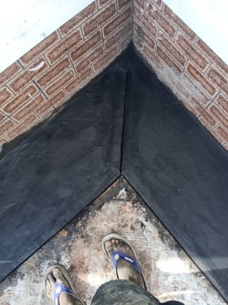 Black surface floor finish with brick trim detail